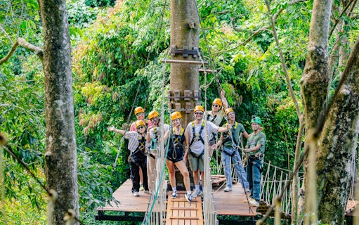 Group ziplining adventure at Sky Rock Roller in Khao Lak amidst lush forest.