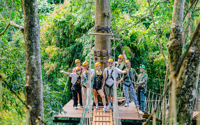Group ziplining adventure at Sky Rock Roller in Khao Lak amidst lush forest.