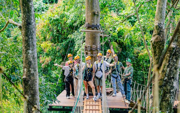 Group ziplining adventure at Sky Rock Roller in Khao Lak amidst lush forest.