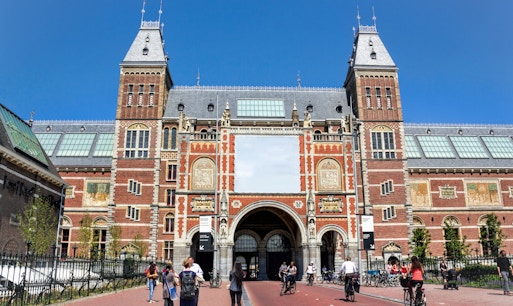 Visitors exploring art exhibits at the Rijksmuseum in Amsterdam.