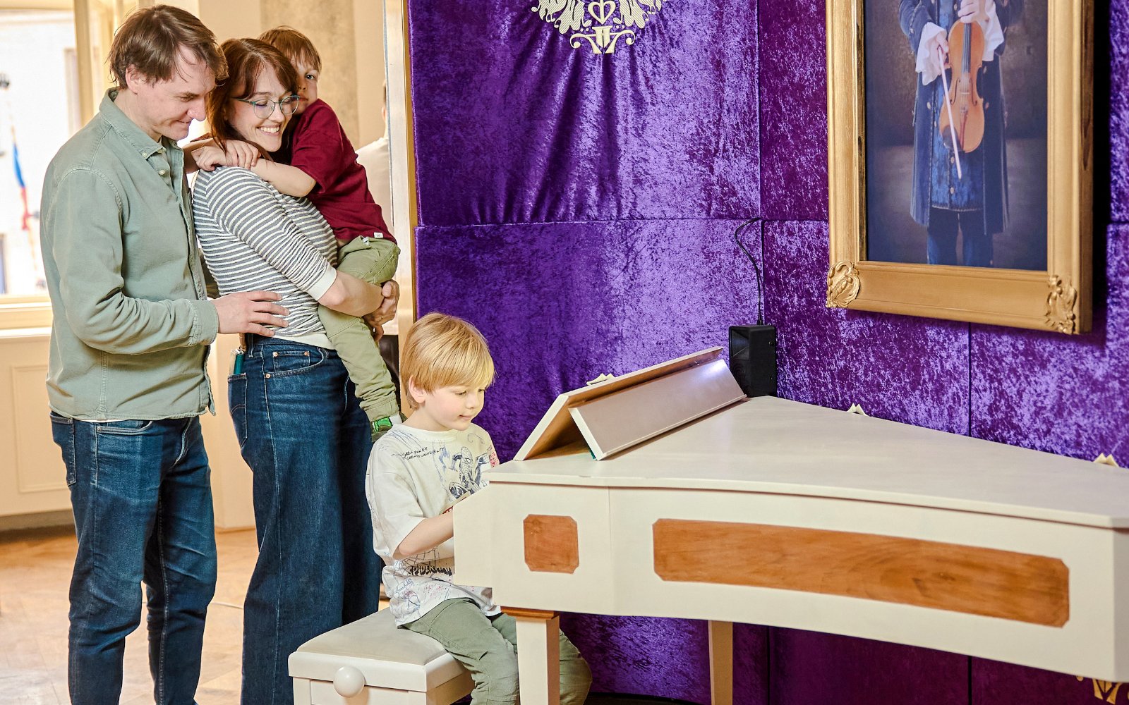 Guests enjoying interactive exhibits at Mozart Museum in Prague.