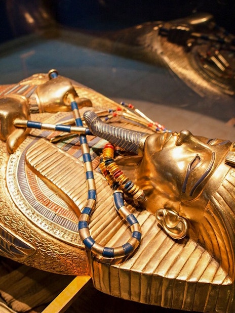 Golden sarcophagus of an Egyptian pharaoh displayed at the Grand Egyptian Museum.