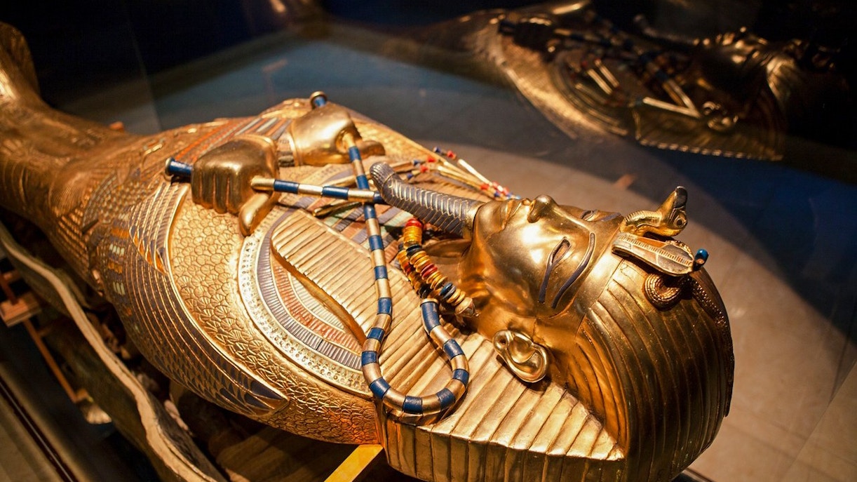 Golden sarcophagus of an Egyptian pharaoh displayed at the Grand Egyptian Museum.
