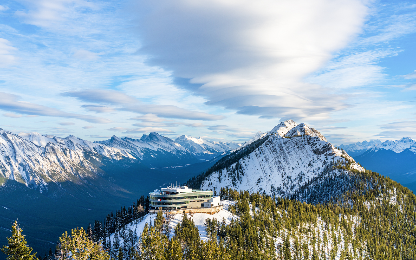 Banff Gondola summit station with snow-covered mountains in Banff National Park.