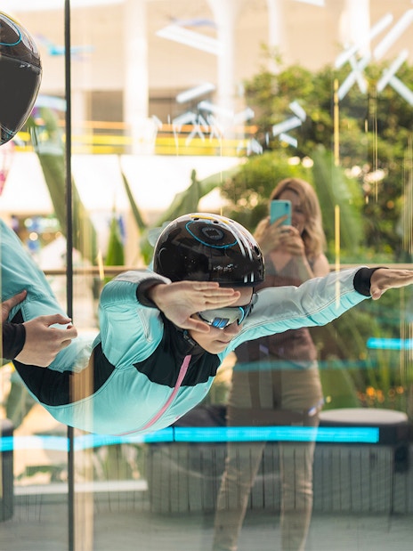 Young girl with instructor in iFly Dubai indoor skydive experience.