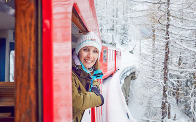 Train ride through snowy Chamonix Mont Blanc with passenger enjoying the view.