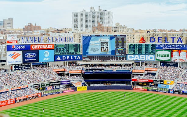 Yankee Stadium view with scoreboard and crowd during Yankees Classic Stadium Tour.
