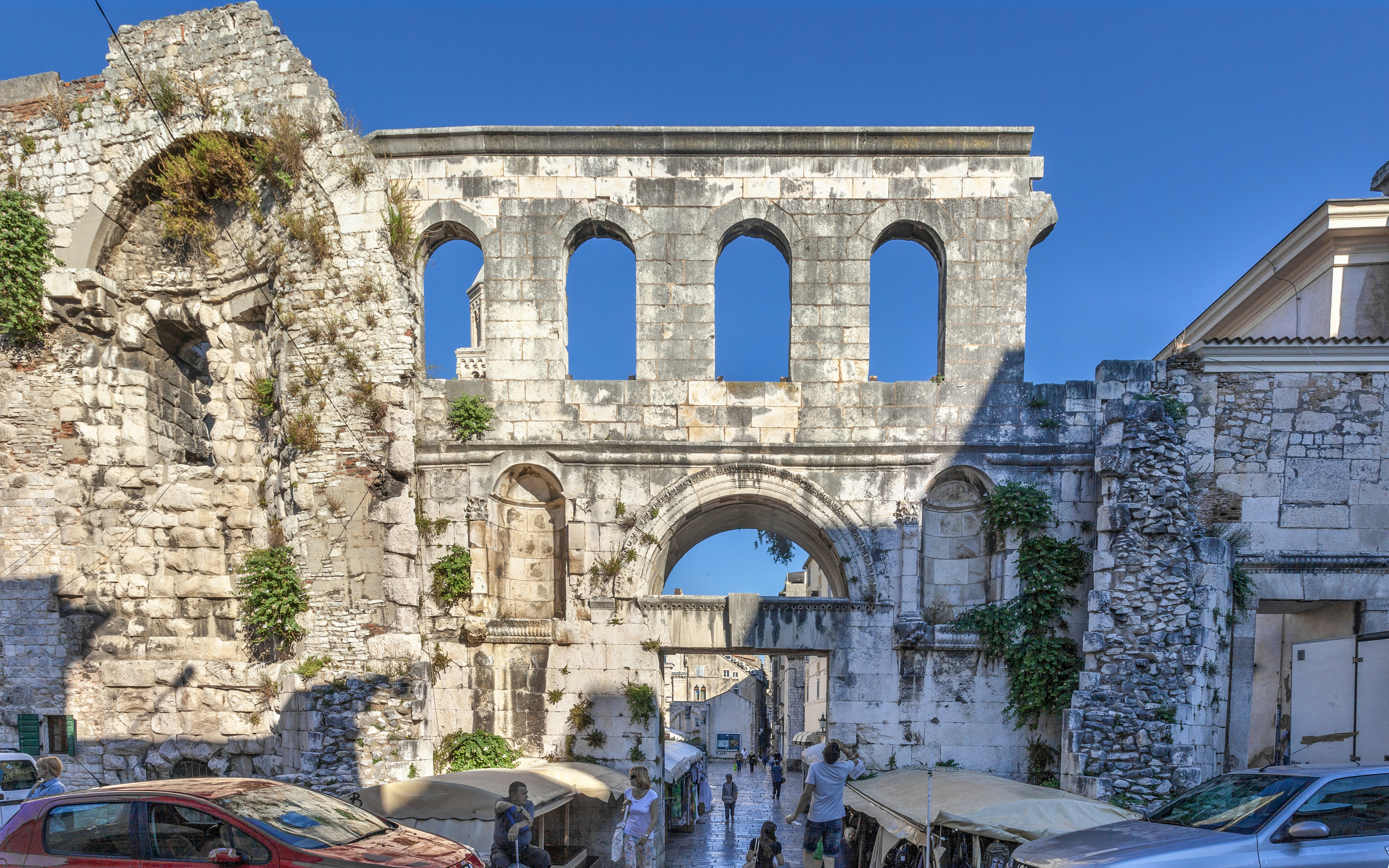 Silver Gate at Diocletian's Palace in Split with tourists exploring the ancient stone structure.