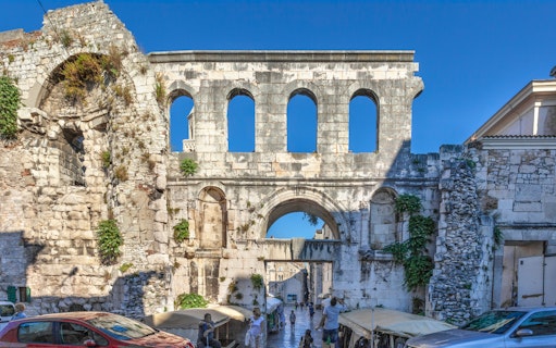 Silver Gate at Diocletian's Palace in Split with tourists exploring the ancient stone structure.