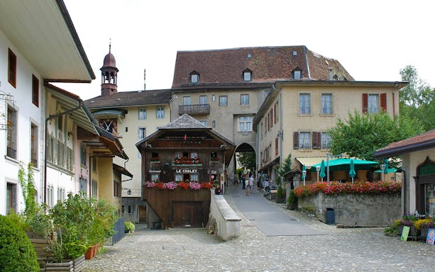 Gruyères village street view with historic buildings on a guided tour from Basel.