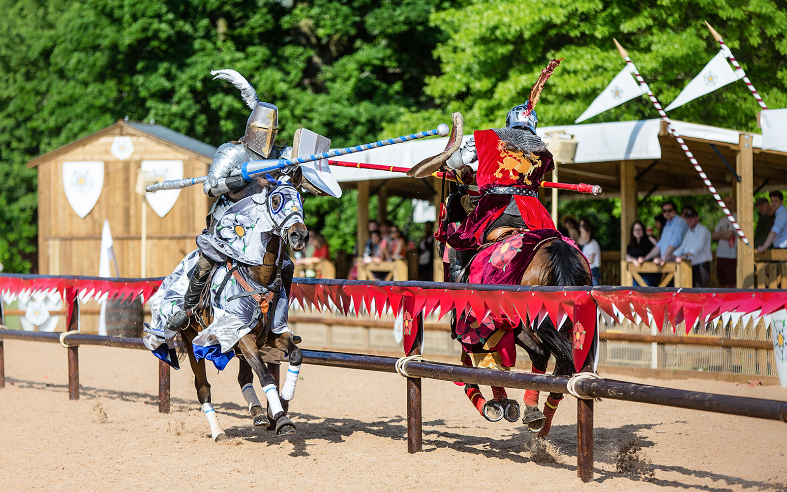 Jousting knights on horseback at Warwick Castle event.
