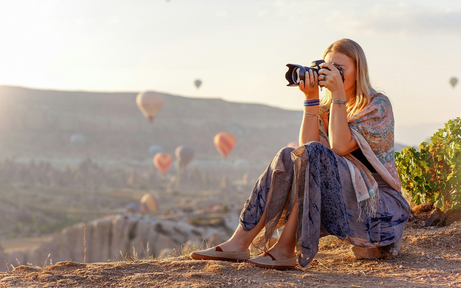 Photographer capturing hot air balloons in Cappadocia, Turkey.
