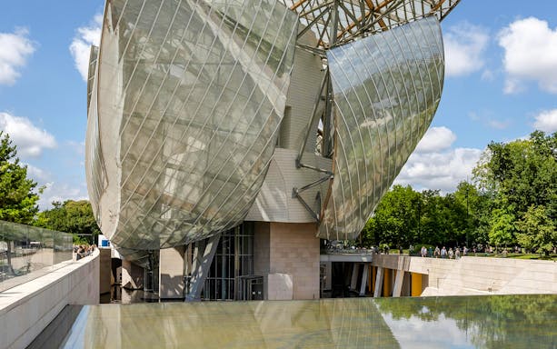 Louis Vuitton Foundation's glass architecture with reflecting pool, Paris, France.