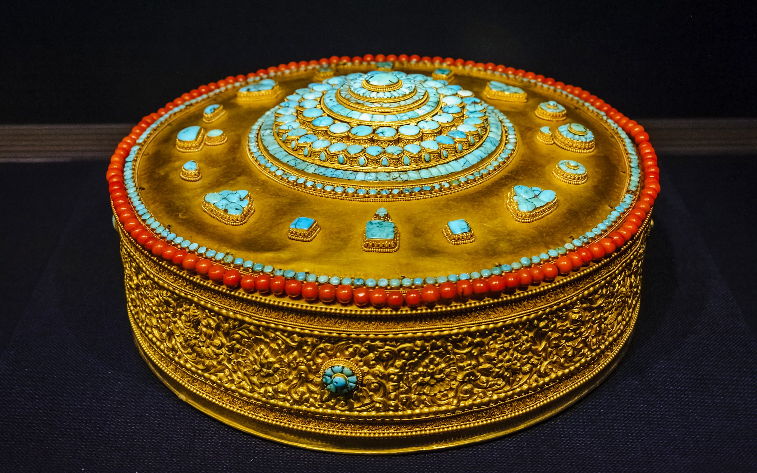 Tibetan Buddhist mandala adorned with turquoise and coral at Taiwan Palace Museum.