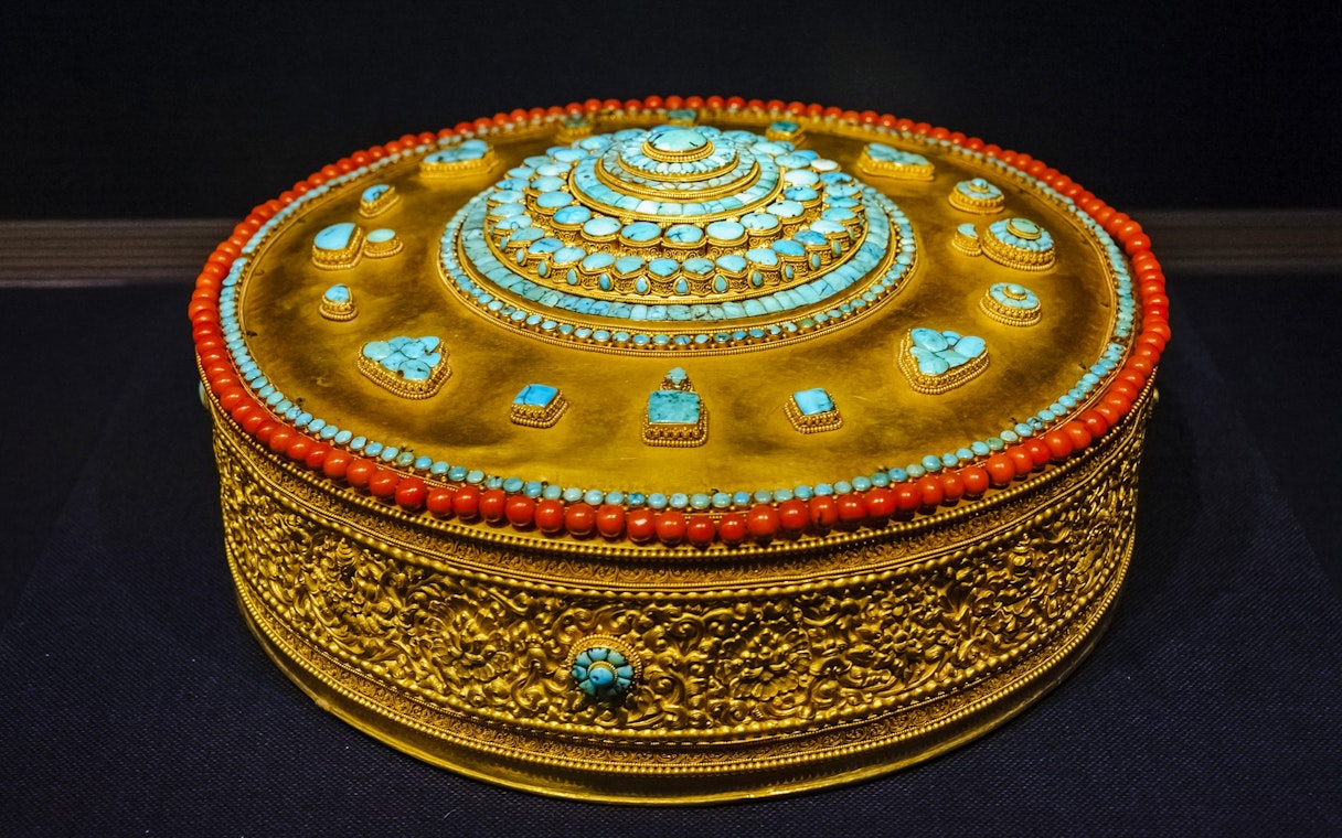 Tibetan Buddhist mandala adorned with turquoise and coral at Taiwan Palace Museum.