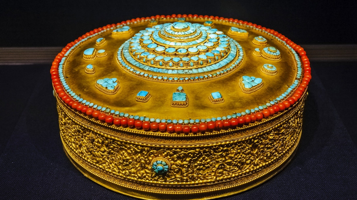 Tibetan Buddhist mandala adorned with turquoise and coral at Taiwan Palace Museum.