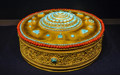 Tibetan Buddhist mandala adorned with turquoise and coral at Taiwan Palace Museum.