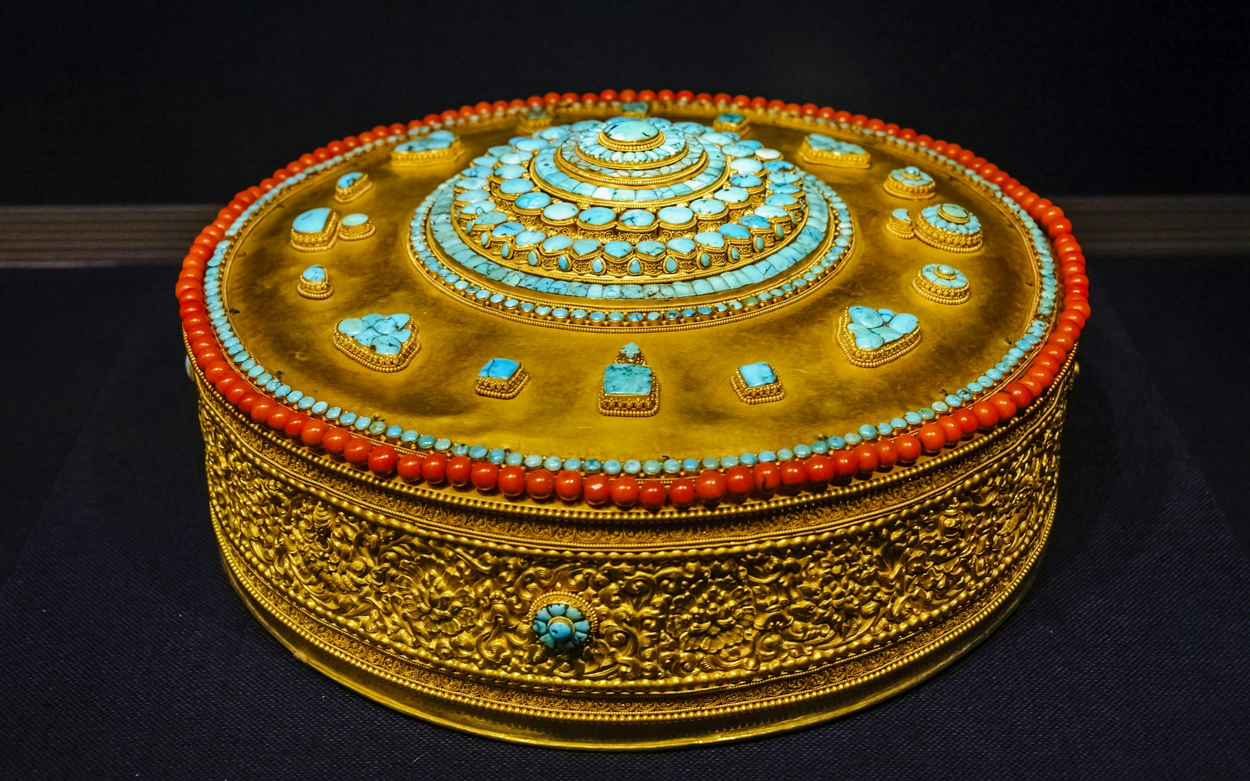 Tibetan Buddhist mandala adorned with turquoise and coral at Taiwan Palace Museum.