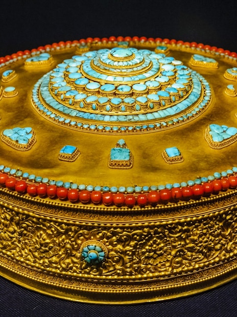 Tibetan Buddhist mandala adorned with turquoise and coral at Taiwan Palace Museum.