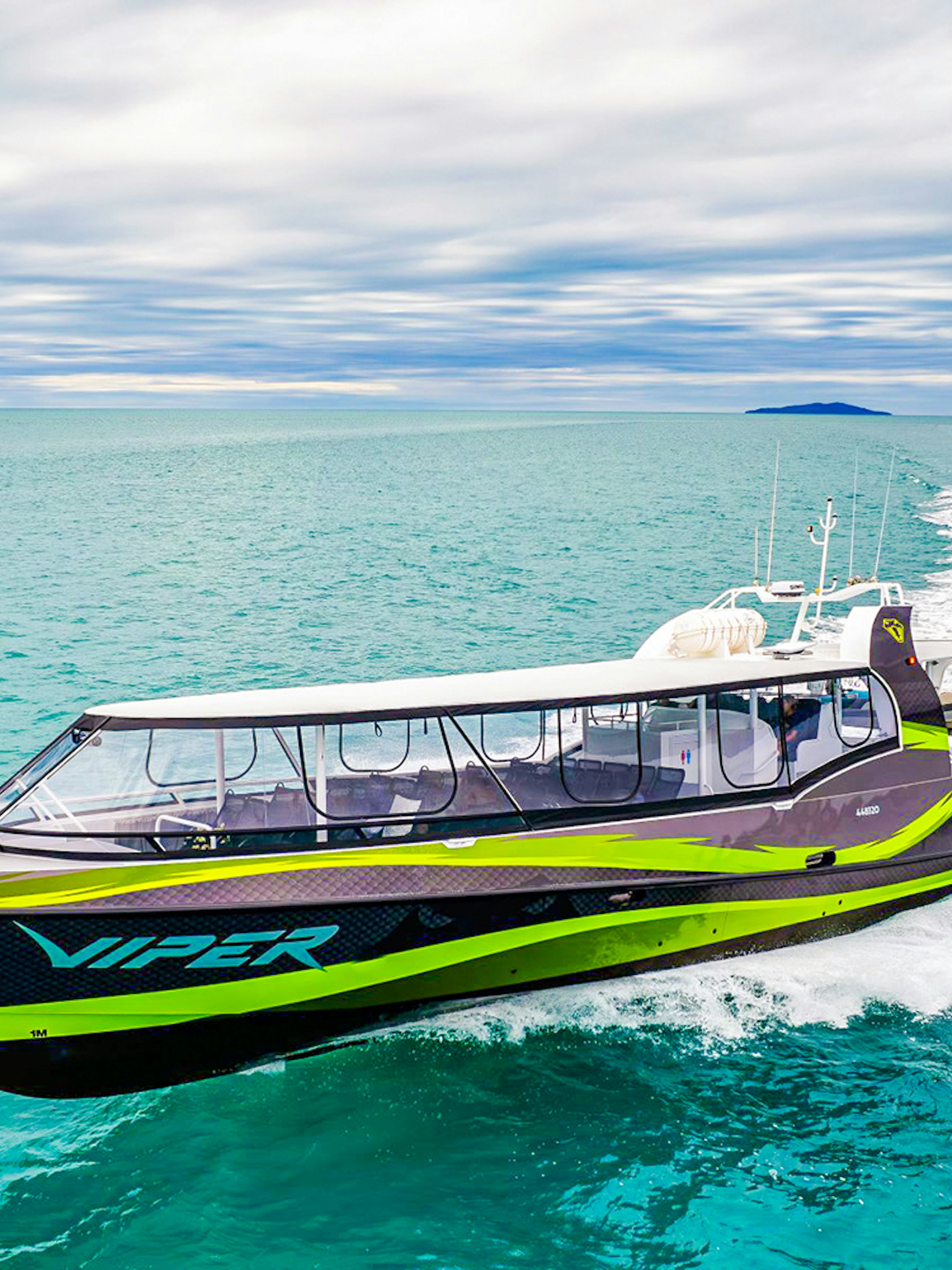 Viper boat cruising through turquoise waters in the Whitsundays.