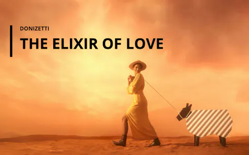 Person in yellow dress walking a striped animal cutout in a desert setting, "The Elixir of Love" text.