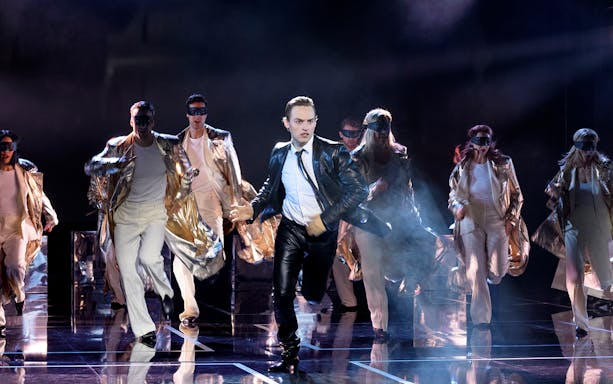 Performers in gold costumes and masks on stage during ROCK ME AMADEUS – THE FALCO MUSICAL in Austria.