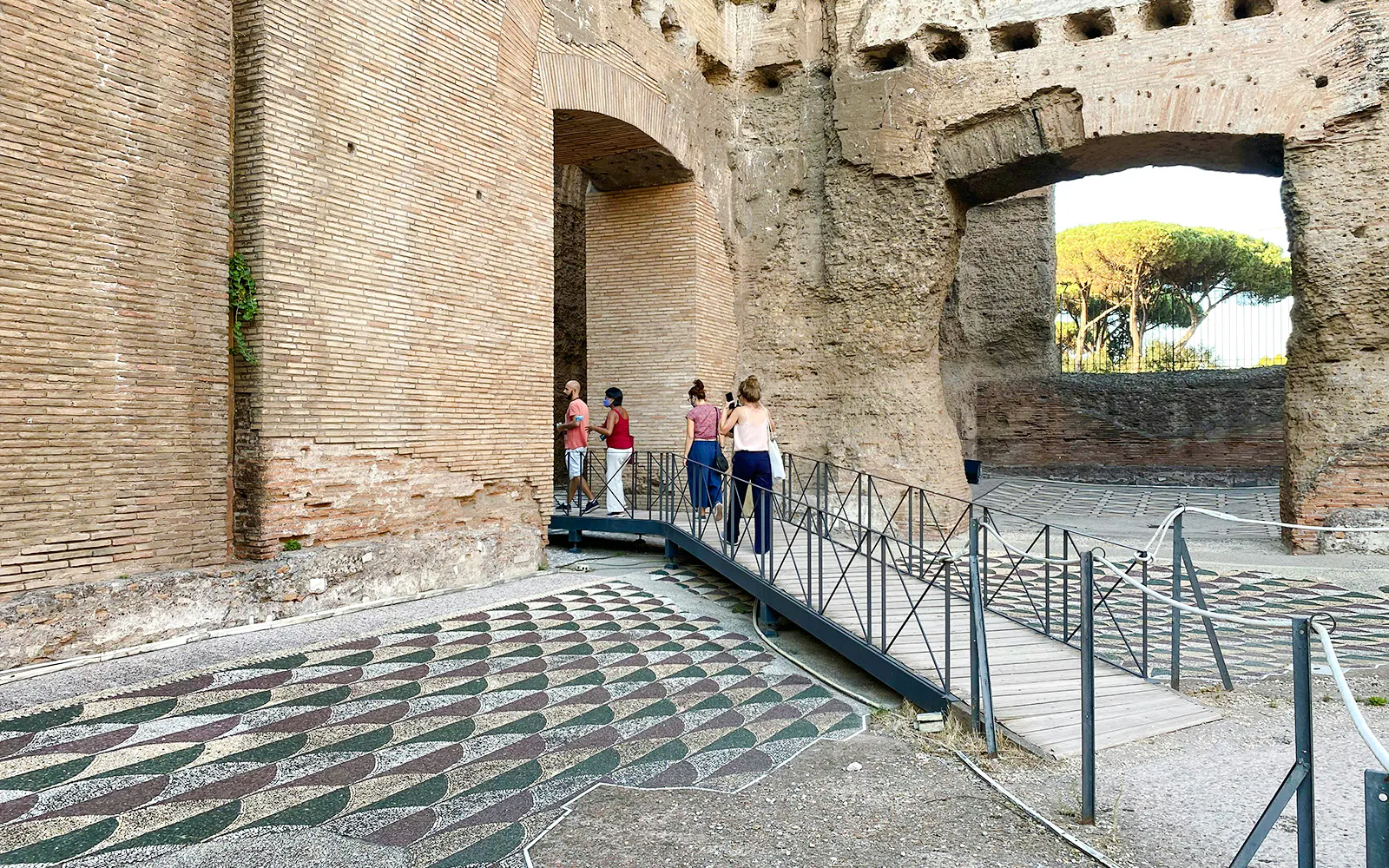 Visitors exploring the ancient ruins of the Baths of Caracalla in Rome.