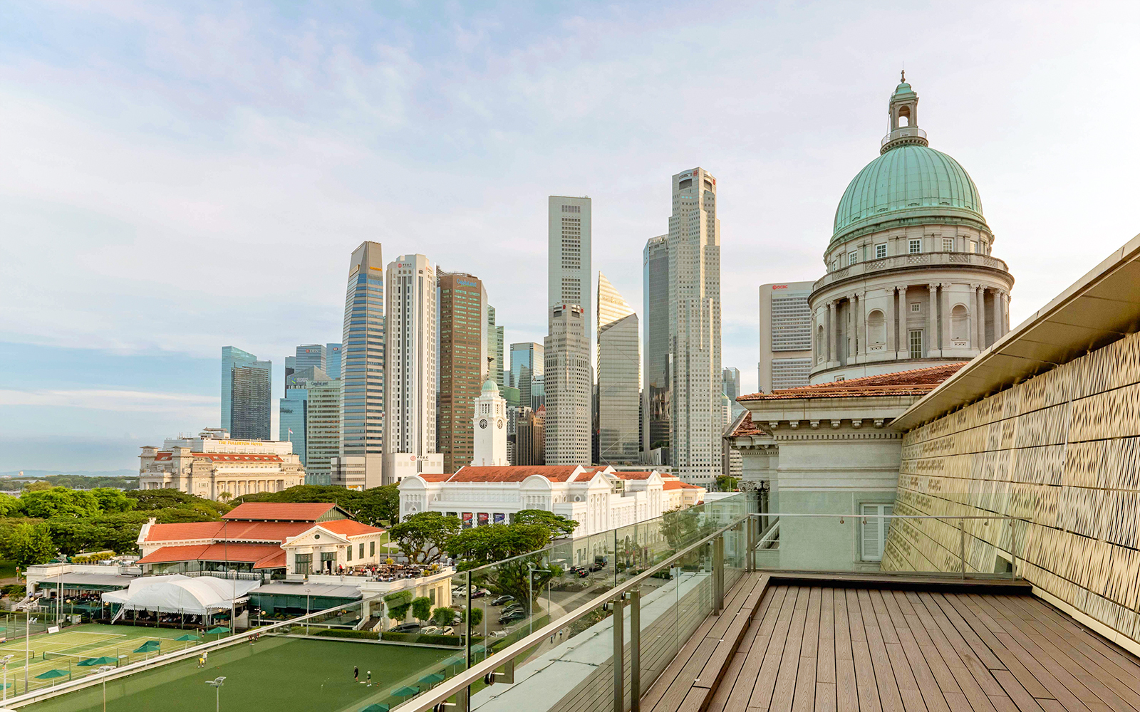 Rooftop view from National Gallery Singapore with city skyline and historic dome.