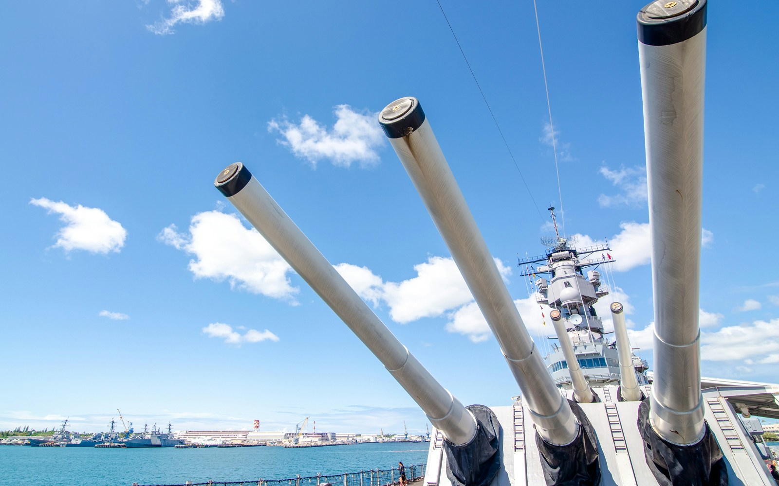 Battleship Missouri Memorial's large naval guns against a clear sky in Pearl Harbor.