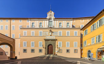 Facade of Castel Gandolfo with clock tower, Italy.
