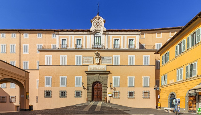 Facade of Castel Gandolfo with clock tower, Italy.