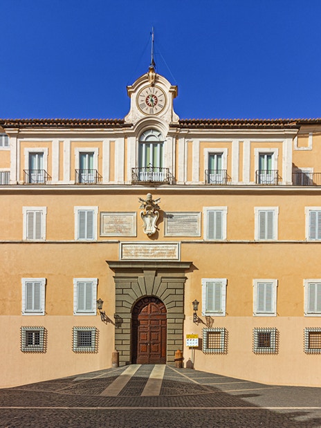Facade of Castel Gandolfo with clock tower, Italy.