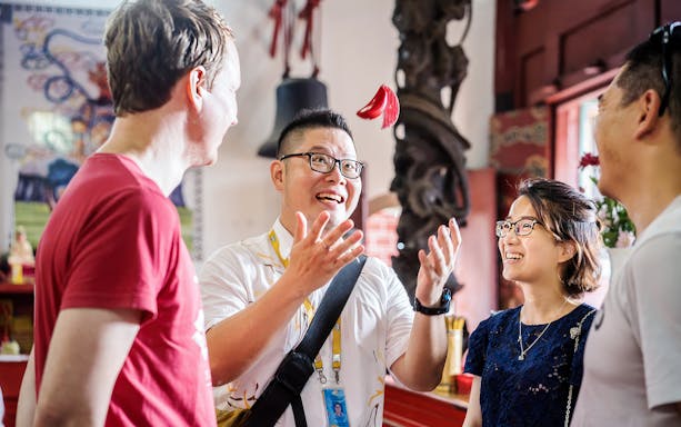 Tour guide entertaining group during Penang street food tour.