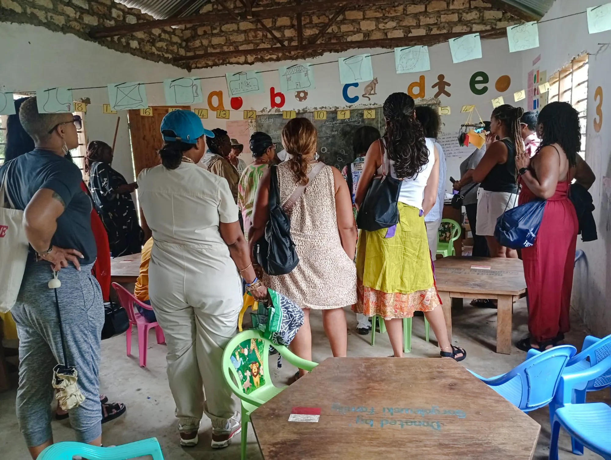 Visitors observing a classroom in a local village during the Diani: Giriama Cultural Dance Show and Tour.