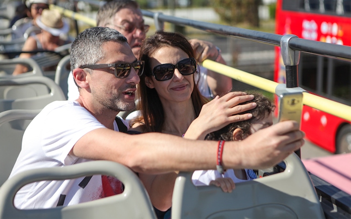 Family taking a selfie on a Corfu sightseeing bus tour.