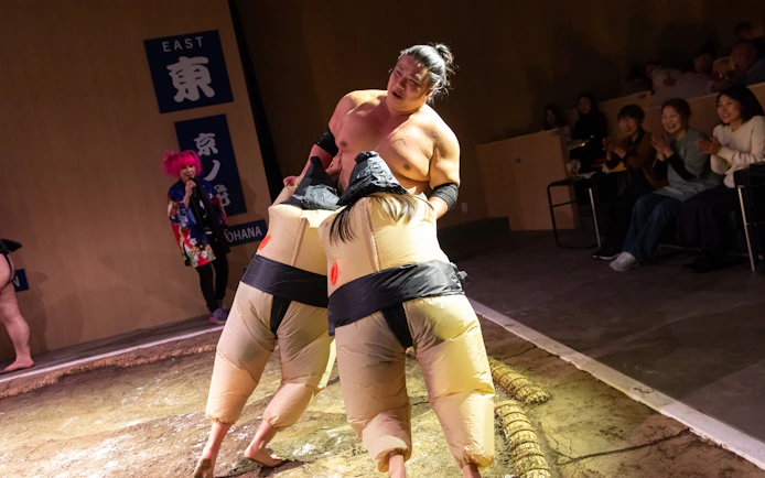 Sumo wrestler performing with audience at Kyoto Sumo Entertainment Show.