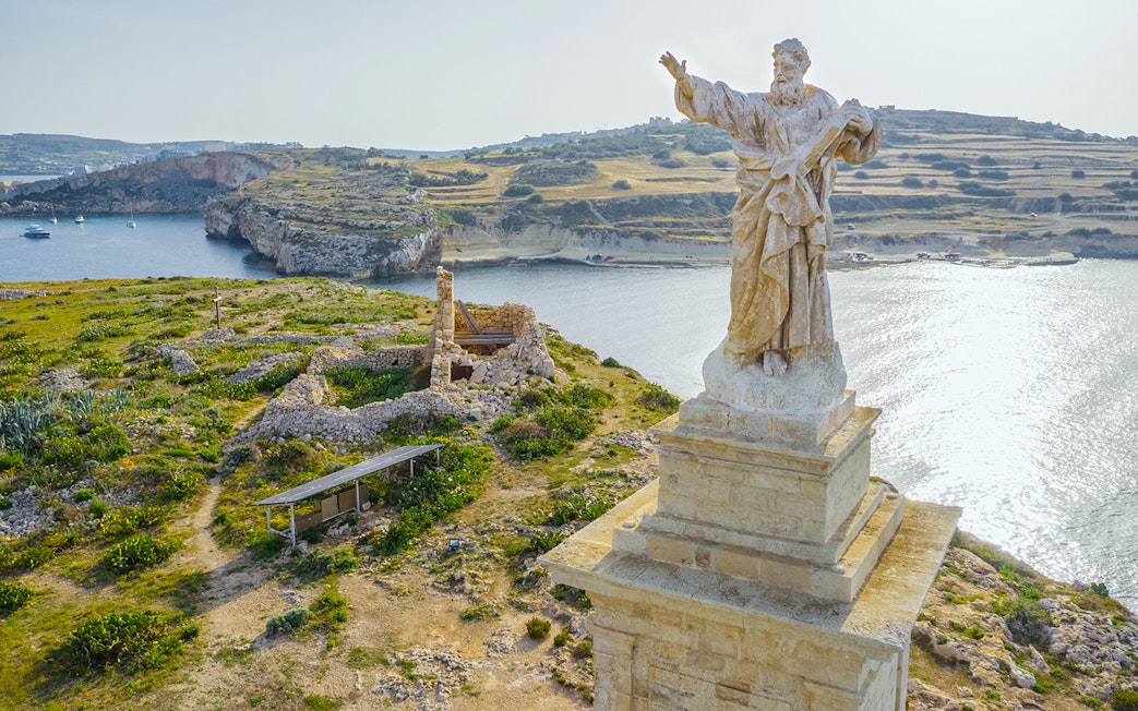 Aerial view of St. Paul's statue overlooking St. Paul's Island, Malta.