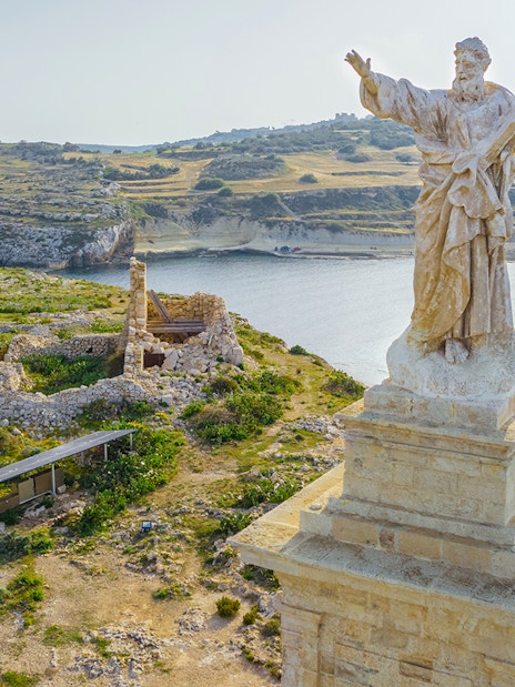 Aerial view of St. Paul's statue overlooking St. Paul's Island, Malta.