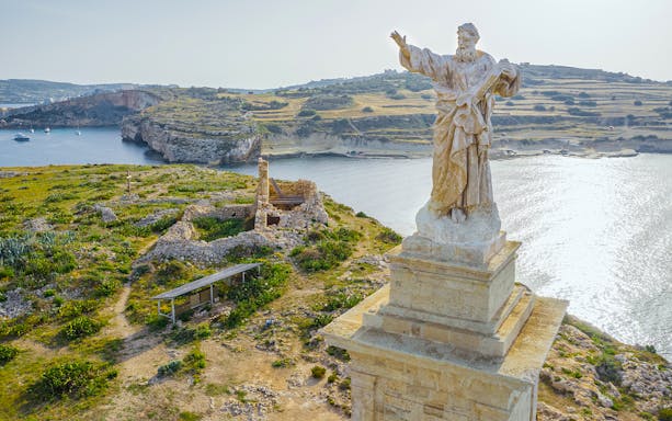 Aerial view of St. Paul's statue overlooking St. Paul's Island, Malta.