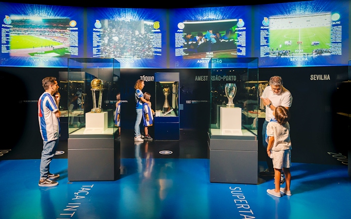 Visitors at FC Porto stadium museum viewing trophies in the trophy room.