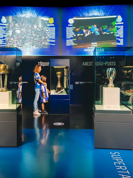 Visitors at FC Porto stadium museum viewing trophies in the trophy room.