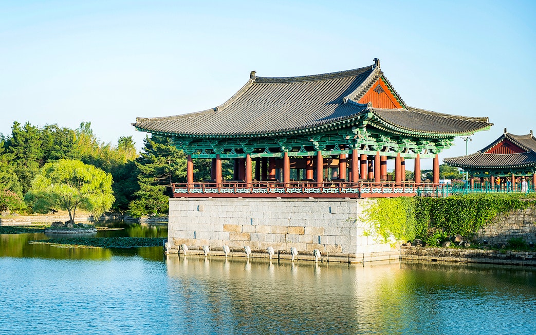 Traditional Korean pavilion by a pond in Gyeongju, South Korea, part of UNESCO World Heritage Tour.