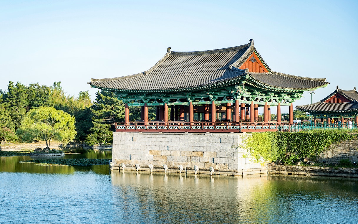 Traditional Korean pavilion by a pond in Gyeongju, South Korea, part of UNESCO World Heritage Tour.