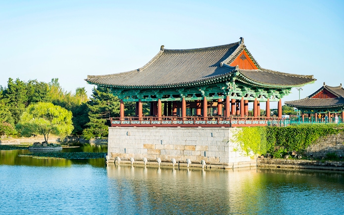 Traditional Korean pavilion by a pond in Gyeongju, South Korea, part of UNESCO World Heritage Tour.