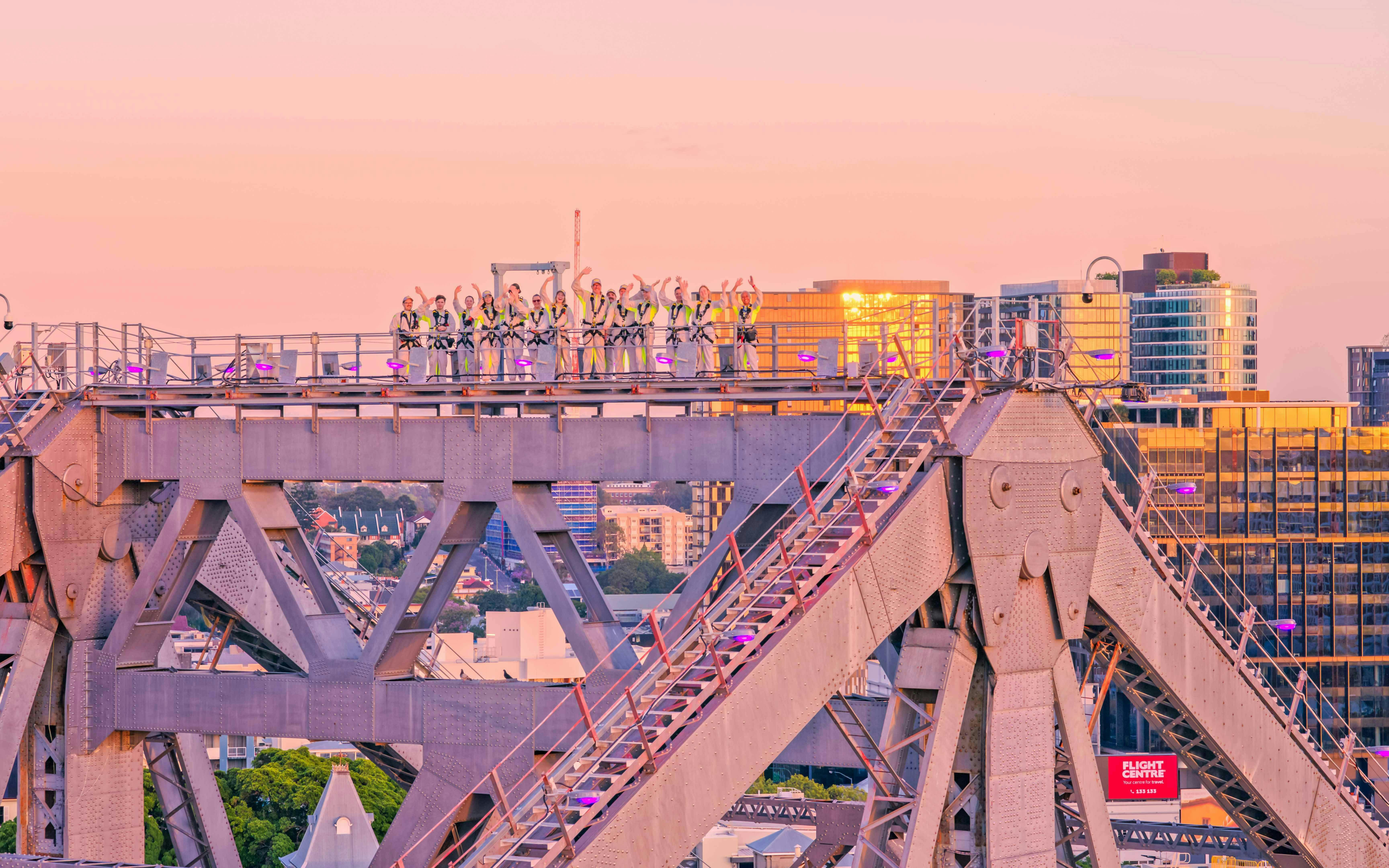 Climbers on Story Bridge during sunset in Brisbane, Australia.