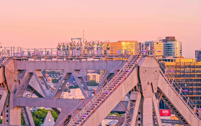 Climbers on Story Bridge during sunset in Brisbane, Australia.