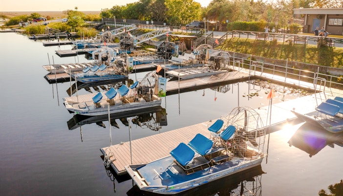Airboats docked at Everglades marina for private 1-hour adventure tour.