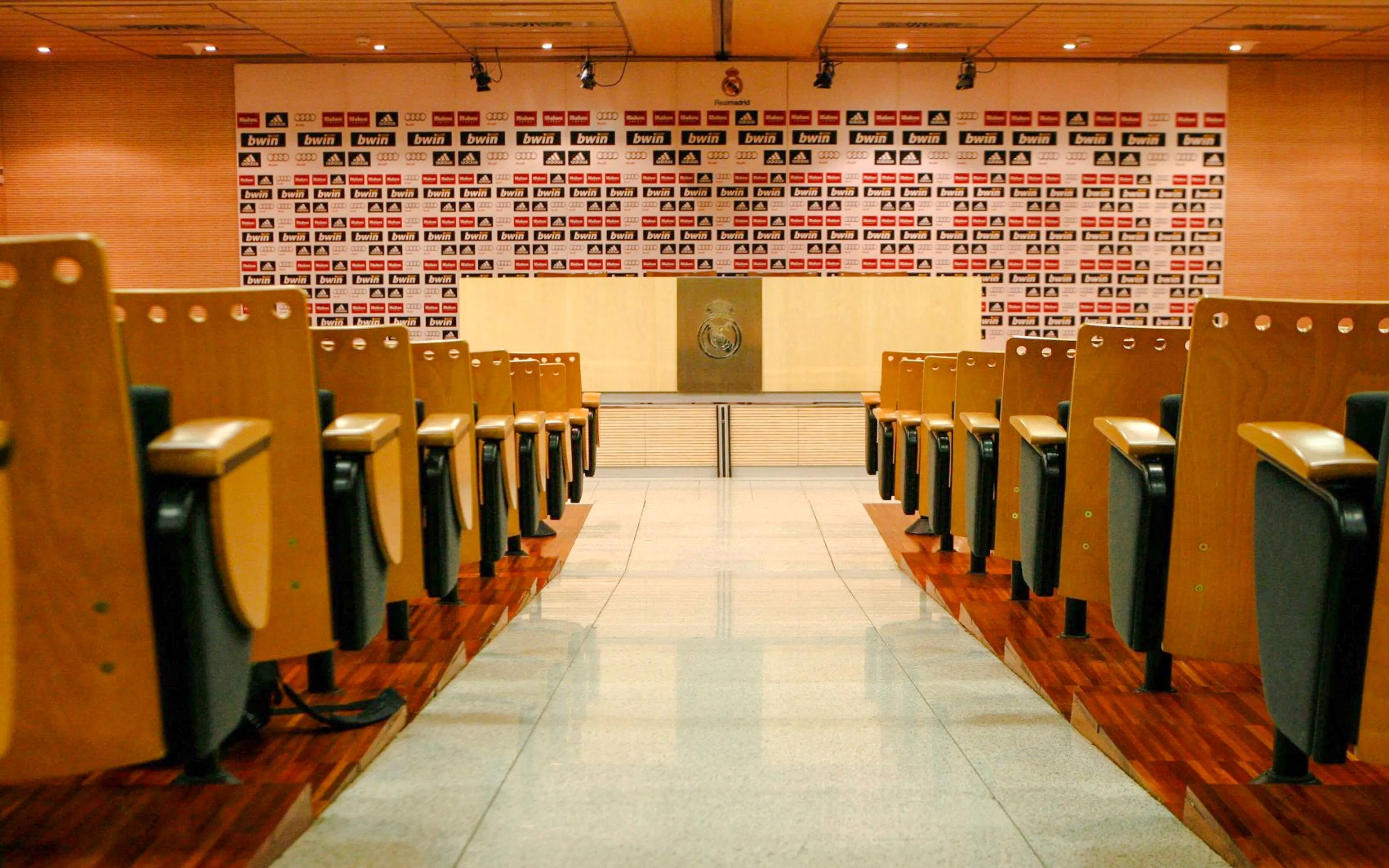 Press room at Bernabeu Stadium with rows of seats and a podium.