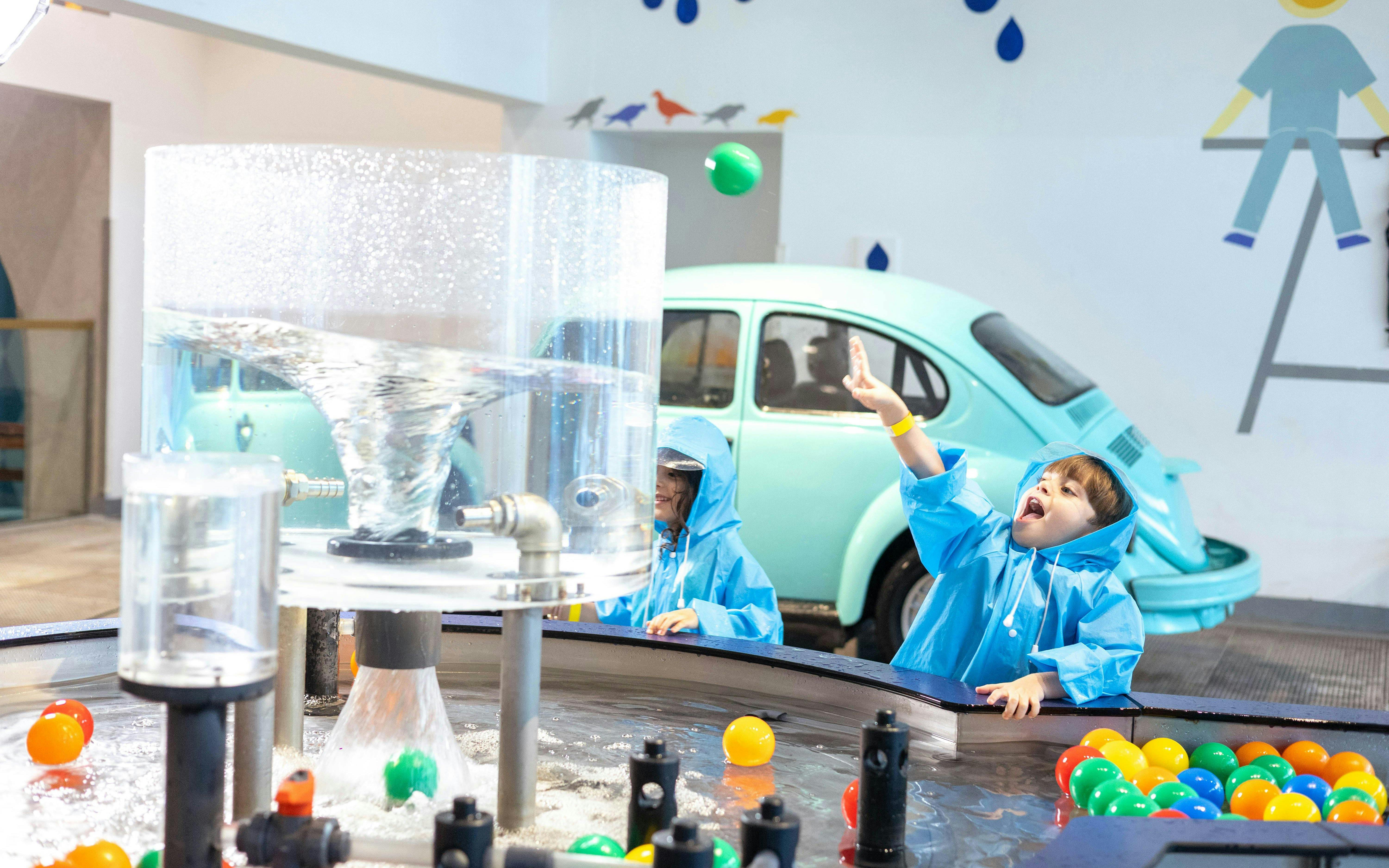 Children playing with water exhibit at OliOli Children's Museum.