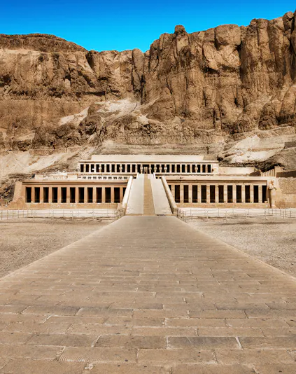 Hatshepsut Temple in Valley of the Kings, Egypt, with rocky cliffs in the background.